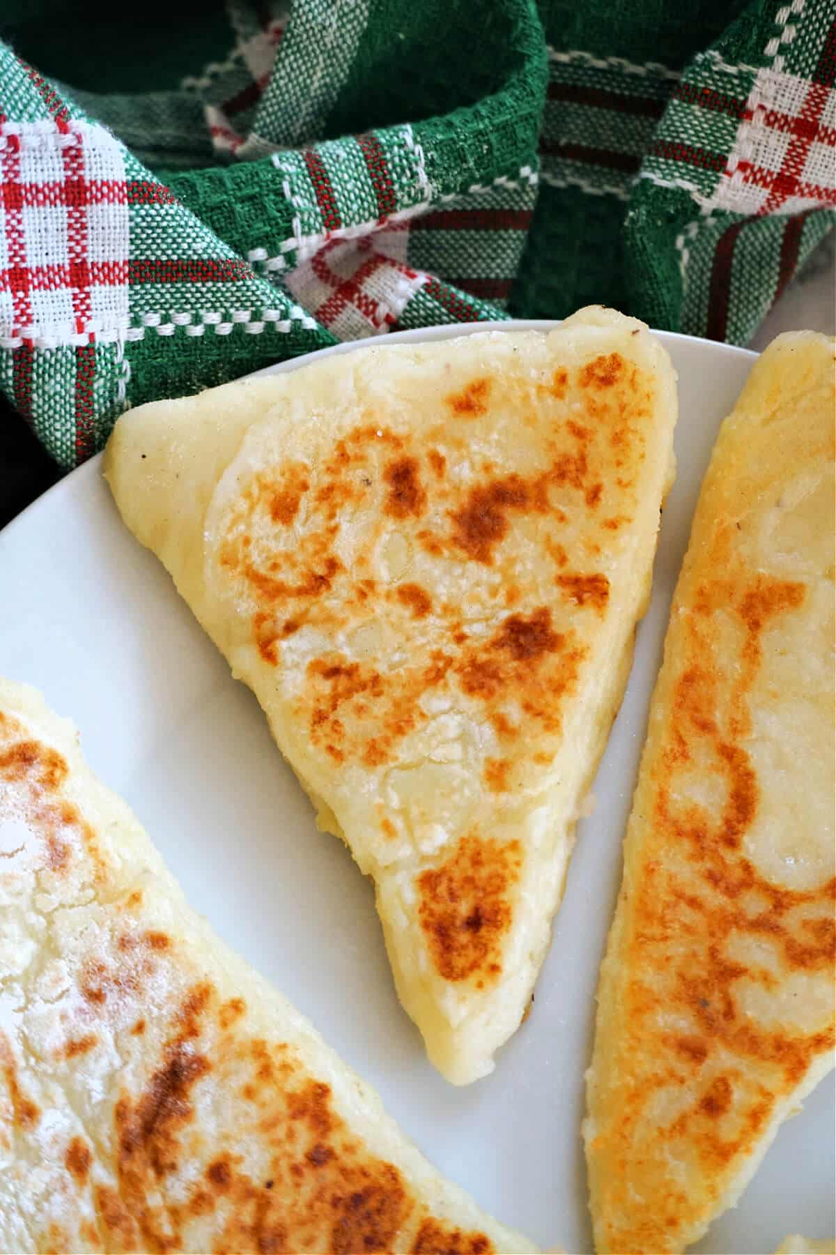 Close-up shoot of a potato cake on a white plate.