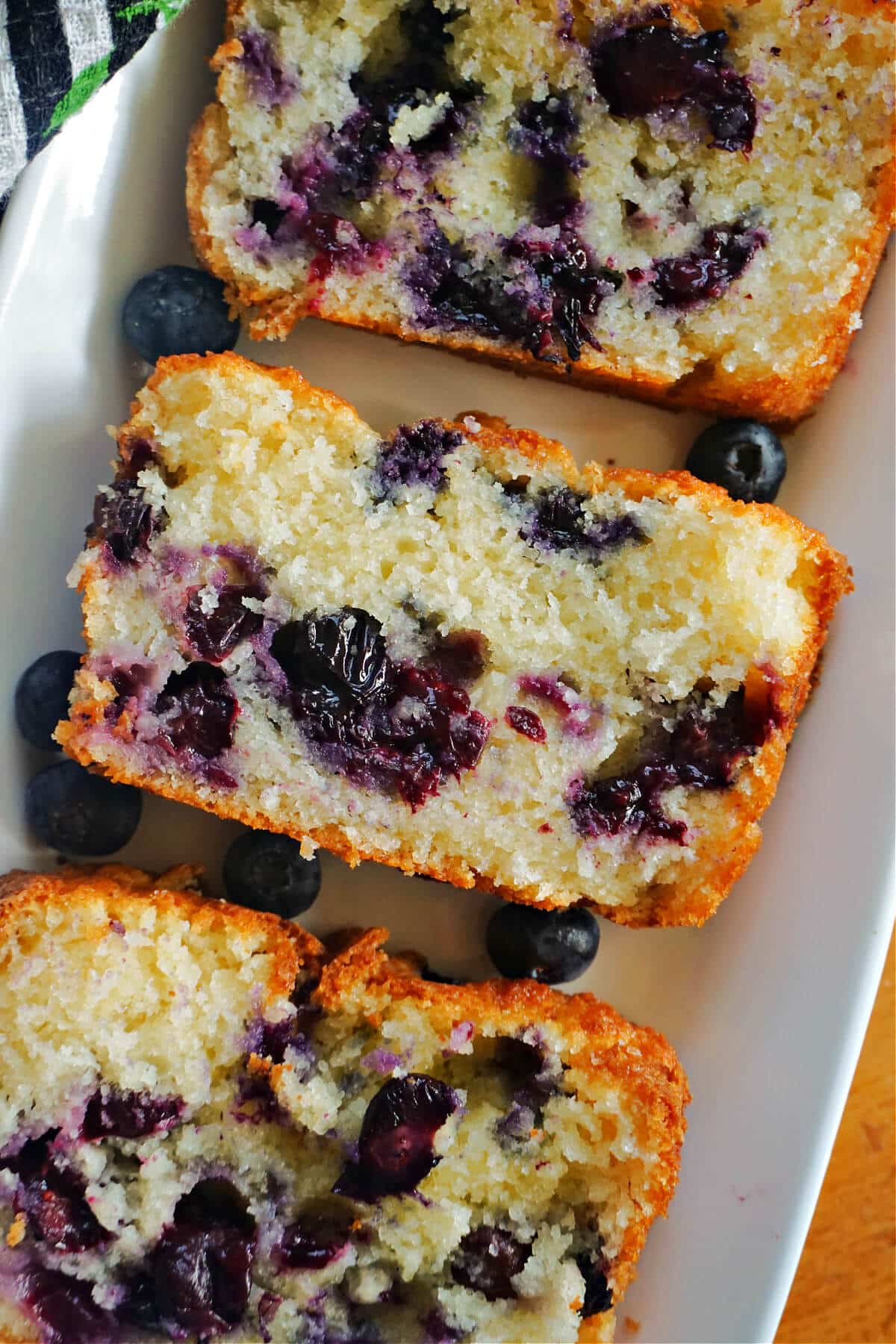3 slices of blueberry cake on a white plate.
