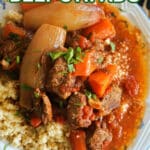 A plate with couscous and beef stew.
