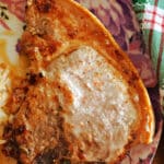 A pork chop on a plate.