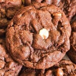 A chocolate chip cookie on top of other cookies.