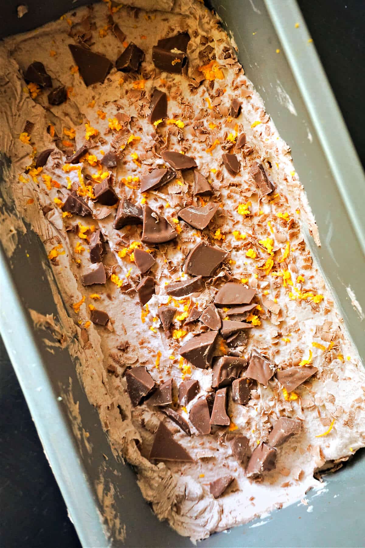A loaf tin with chocolate orange ice cream.