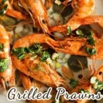 6 grilled prawns on a plate.
