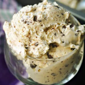 A glass with a scoop of stracciatella ice cream.