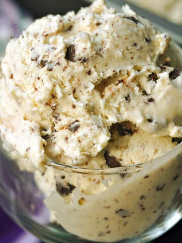 A glass with a scoop of stracciatella ice cream.
