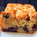 A sliced blackberry cake loaf on a white plate.