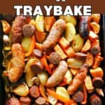A baking tray with sausages and veggies.