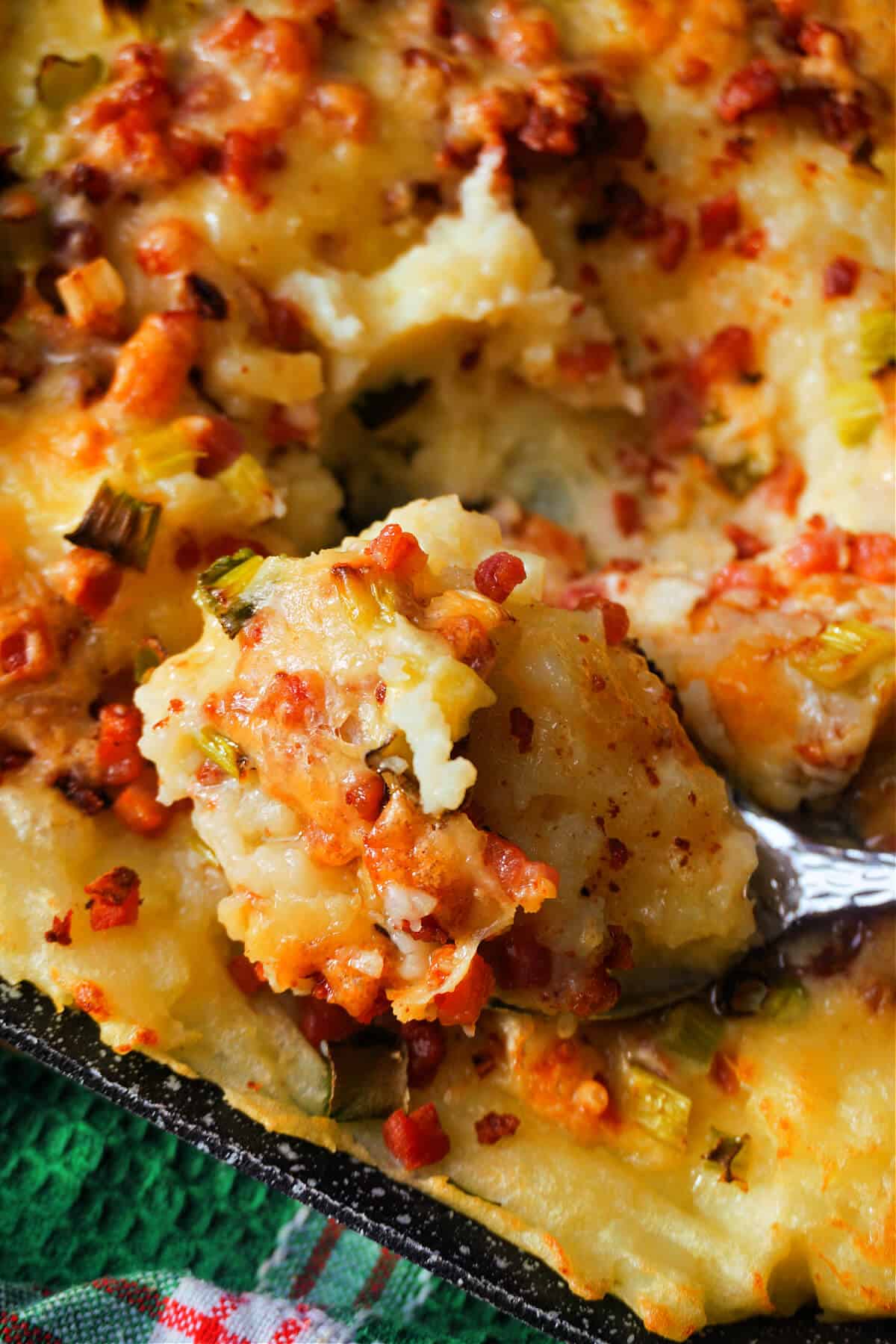 Close-up of a spoonful of a mash casserole over the casserole dish.