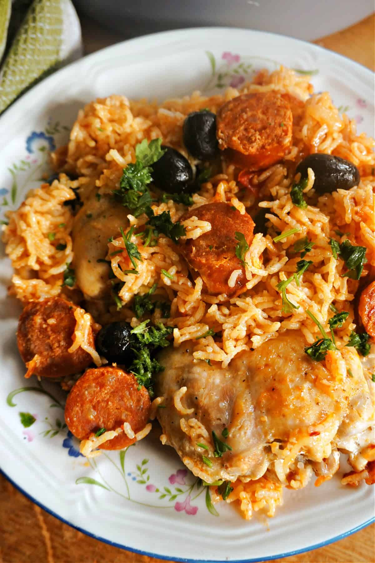 A plate with chicken and chorizo rice.