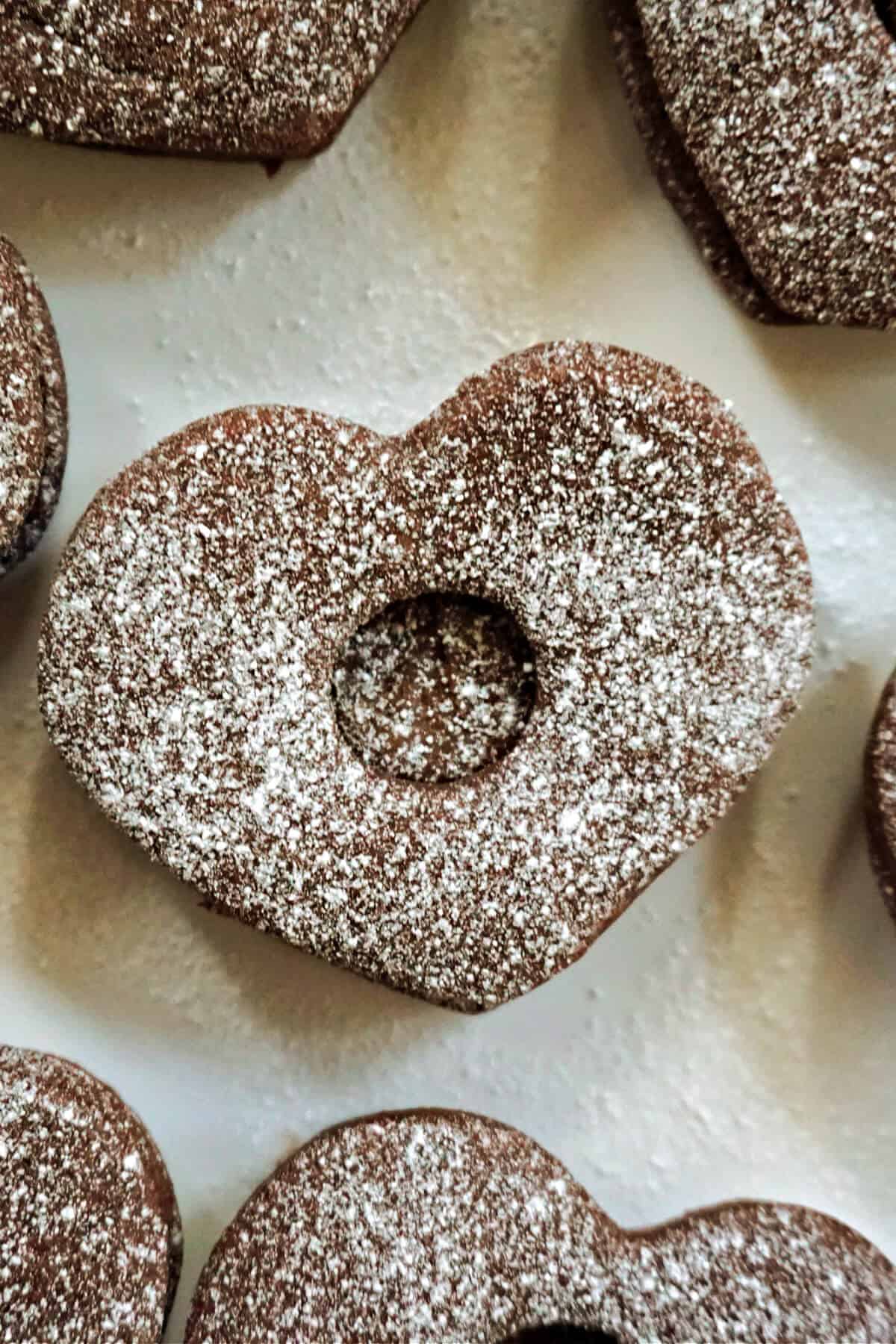 A heart-shaped chocolate cookie stuffed with nutella and dusted with icing sugar.