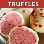 A small bowl with 2 halves of a raspberry and white chocolate truffles and 2 whole truffles topped with freeze-dried raspberries.