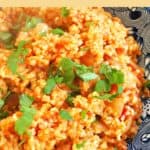 A blue plate with bulgur pilaf garnished with chopped parsley.