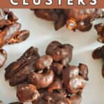 A chocolate nut cluster on a white plate.