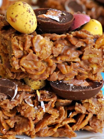 A stack of 2 chocolate cornflake squares topped with mini chocolates.