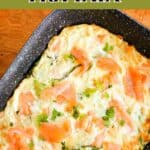 A roasting tray with frittata topped with smoked salmon and chopped parsley.