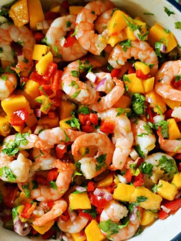 A bowl with mango and prawn salsa.