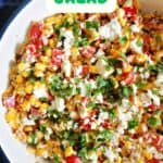 A white bowl with corn salad.