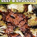 Close-up of beef and broccoli in sauce garnished with sesame seeds.