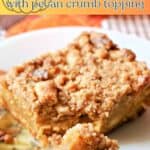 A slice of pumpkin crumb cake on a white plate.