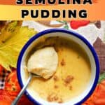 A white ramekin with blue rim with a teaspoon of semolina pudding on top of the pudding. Autumn decorations around.