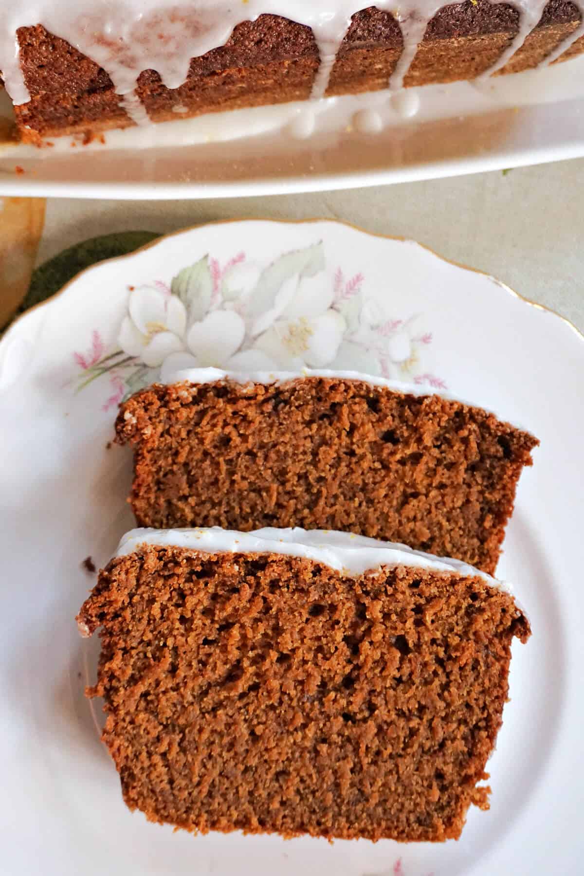 A white plate with 2 slices of gingerbread cake.