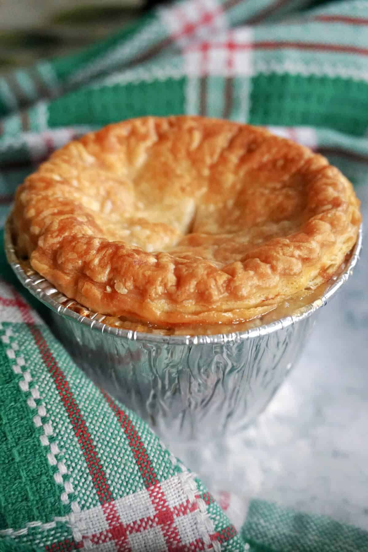 A mini pie in an aluminum case.