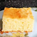 A slice of sponge cake on a white flowery plate.