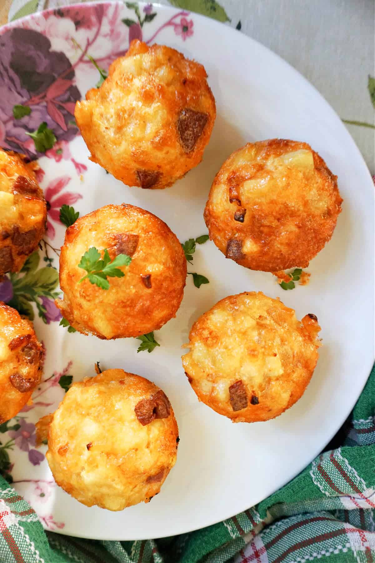 A partially-visible plate with 7 mini egg muffins.