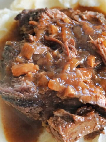 Shredded beef smothered in onion gravy over a bed of mashed potatoes.