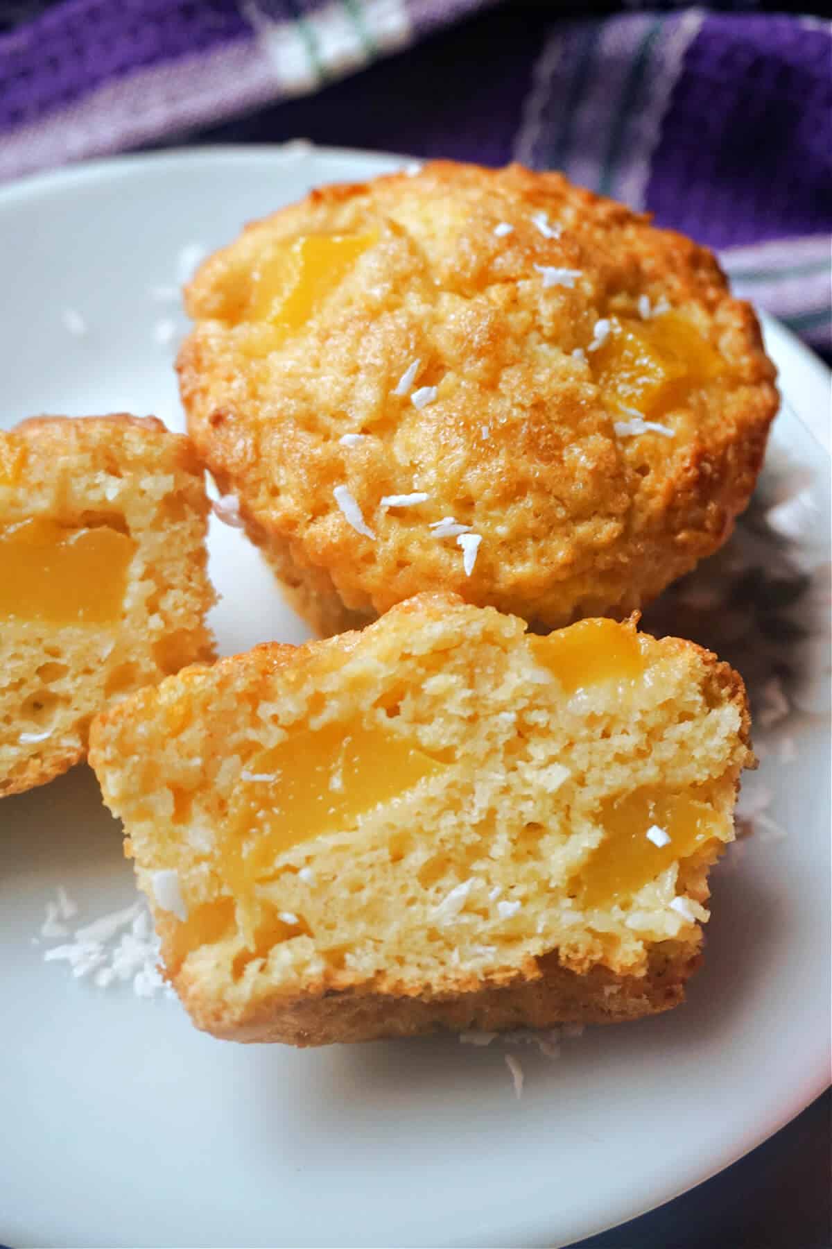 2 halves of a mango muffin with a whole muffin at the top.