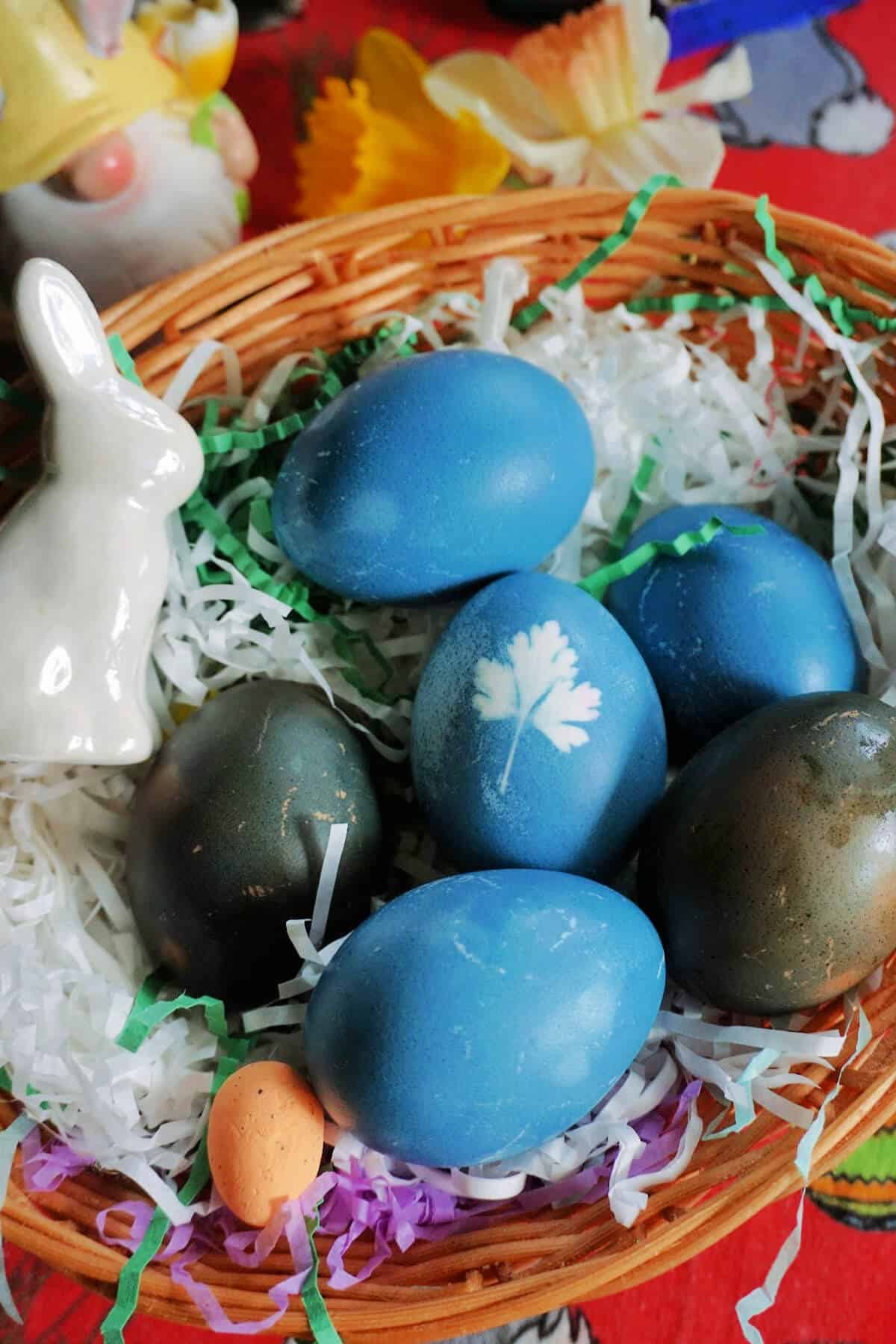 A basket with Easter eggs and decorations.