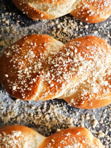 A tray with 3 pastries topped with finely chopped walnuts.