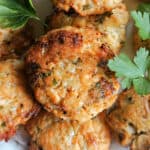 Salmon patties garnished with fresh parsley leaves.