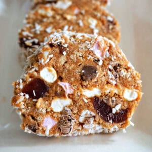 A white plate with 3 slices of cake.