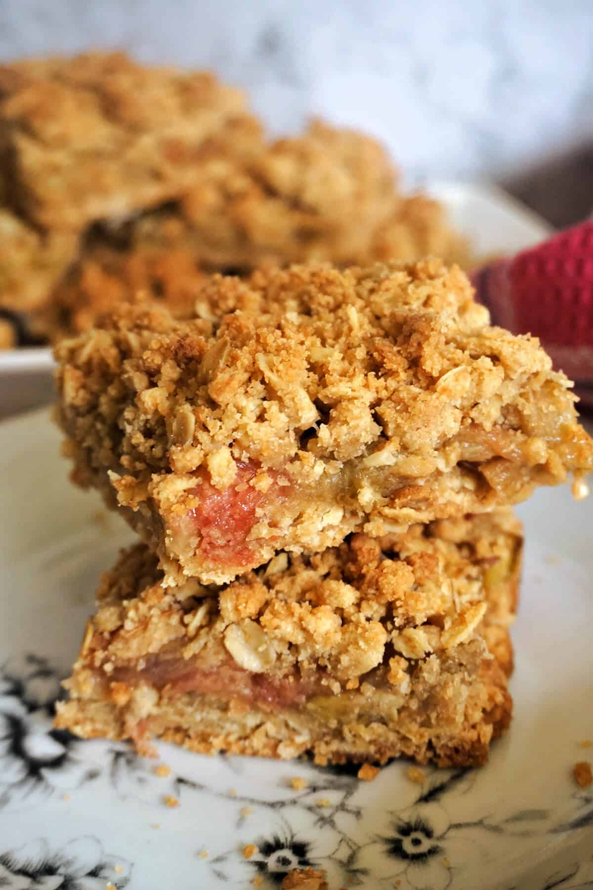 A pile of 2 slices of rhubarb crumble bars.
