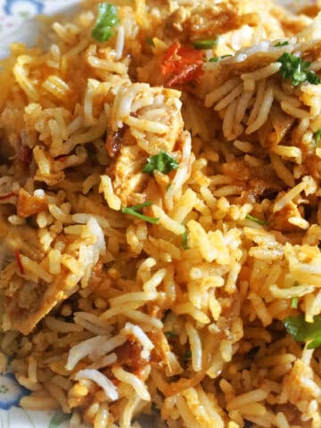A plate with a portion of chicken biryani.