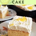 A slice of sponge cake topped with cream and lemon curd on a dessert plate.