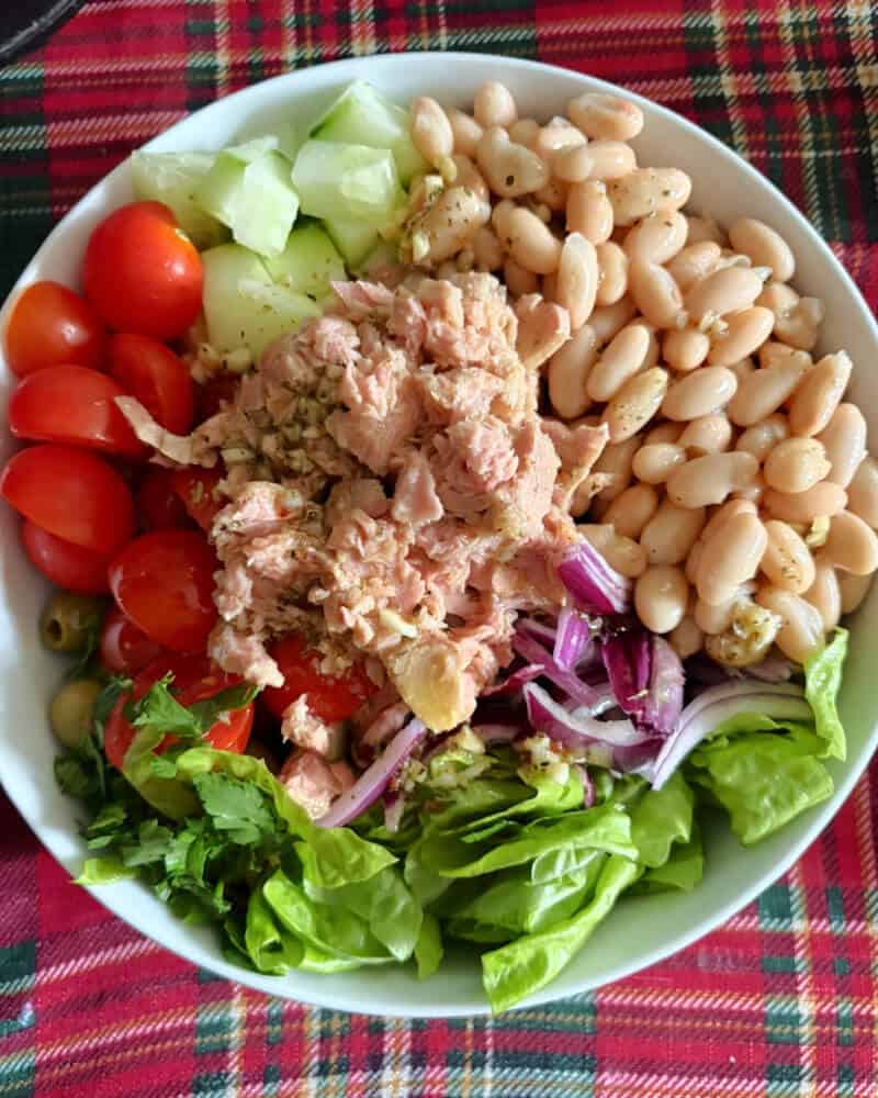A white bowl with all the ingredients for the salad.