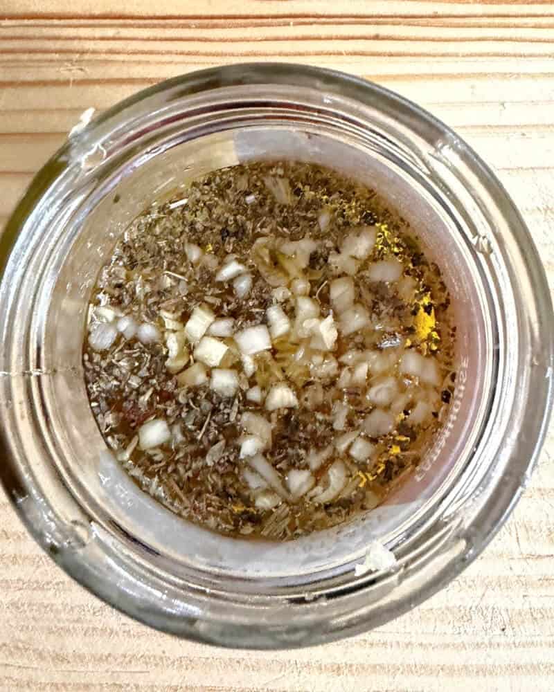 A jar with all the ingredients needed for the dressing.