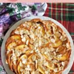A white plate with a peach tart.
