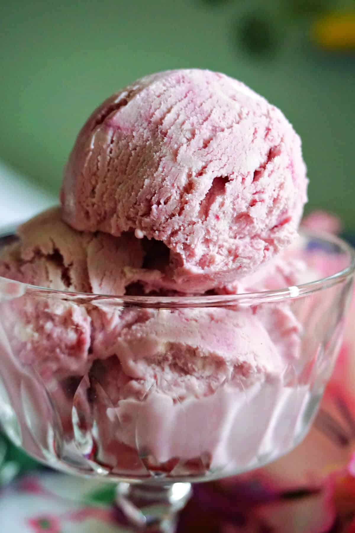 A glass with scoops of blackberry ice cream.