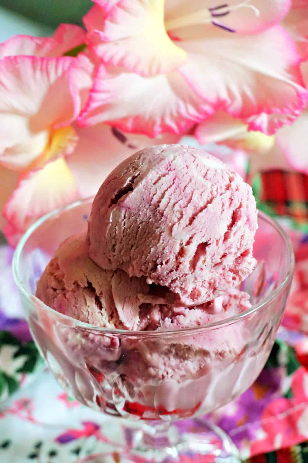 A dessert glass with scoops of ice cream.