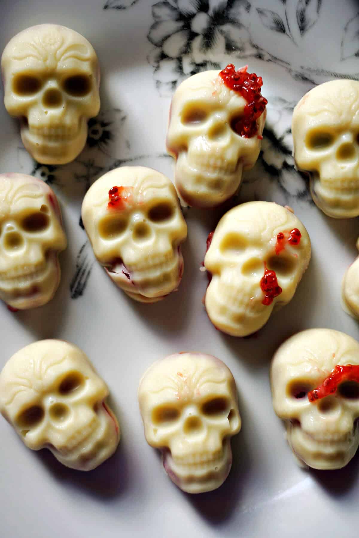 White chocolate skulls on a white plate.