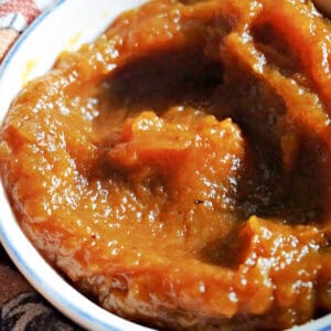 A white ramekin with pumpkin butter.