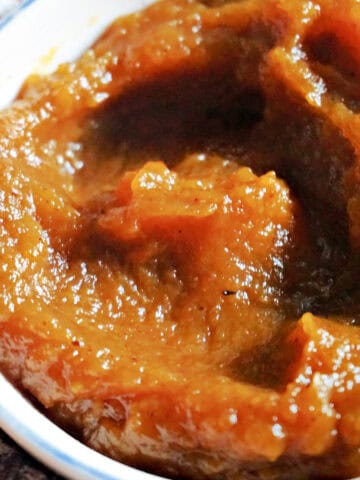 A white ramekin with pumpkin butter.